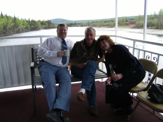 Robert Boles, Howard Colbert and Linda Boisseau sitting on the upper deck enjoing an after dinner drink
