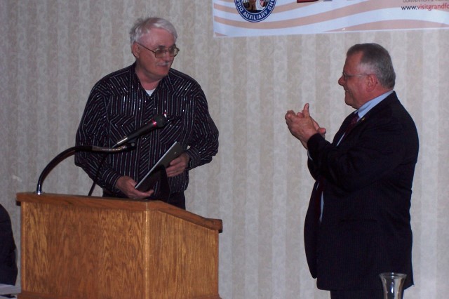 Gerald Bartram, Adjutant from Chapter 5, accepts the award for the Chapter of the Year.  Banquet MC and Convention Chair Mike Dobmeier congratulates the chapter.